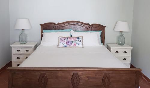 a bedroom with a large bed with two night stands at Casa La Quercia- Tra Cefalù ed il Parco delle Madonie in Gratteri