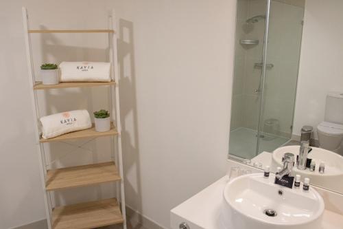 a bathroom with a sink and a shower at Kavia Hotel do Largo in Cascais