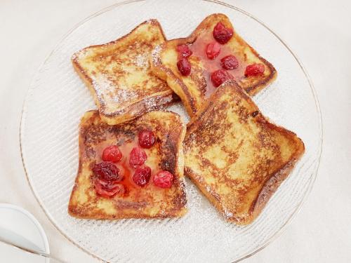 a white plate with two pieces of toast with cherries at Villa Bellavista Alba, B&B in Alba