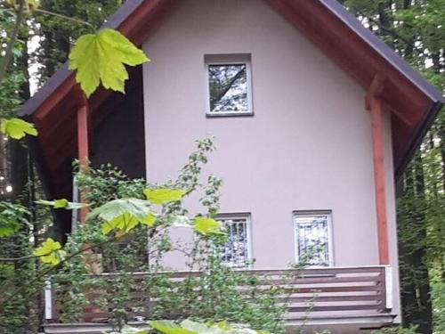 una pequeña casa blanca con una ventana en ella en Peaceful Holiday Home in Hol n with Garden, en Prachov