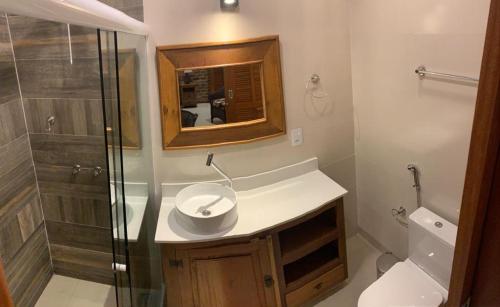 a bathroom with a sink and a shower at ATLANTIC FOREST ROOM in Angra dos Reis