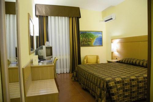 a hotel room with a bed and a television at Il Gelso Bianco in Misterbianco