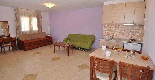 a kitchen and living room with a table and a couch at Elia Studios in Skala Marion