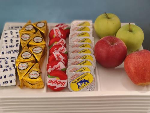 a tray with different types of food and apples at Hôtel La Côte d'Or in Philippeville