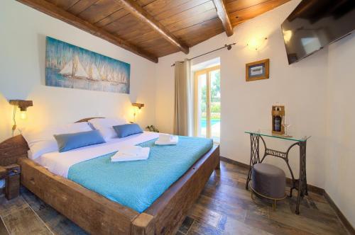 a bedroom with a large bed with a desk and a window at Stone Mill House in Vrh