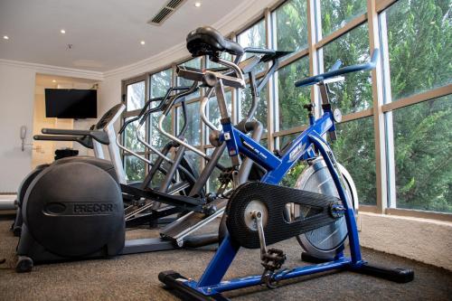 a gym with several exercise bikes in a room with windows at Hotel Victoria Express in Durango