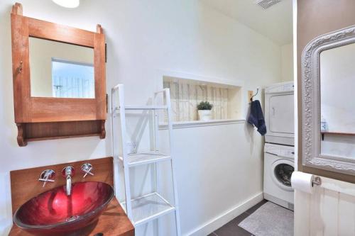 a bathroom with a sink and a mirror at Perfect Loft for a Weekend in the Eastern Townships in Ayer's Cliff
