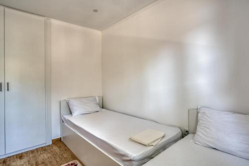 a small room with two beds and a closet at Villa Krofnica in Ulcinj