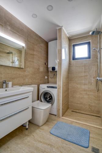 a bathroom with a washing machine and a washer at Villa Krofnica in Ulcinj