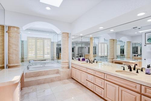a bathroom with two sinks and a tub and a shower at Luxury Estate in Indian Wells Country Club in Indian Wells