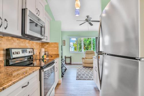 a kitchen with a stainless steel refrigerator at Happiness Comes in Waves in Cape Canaveral