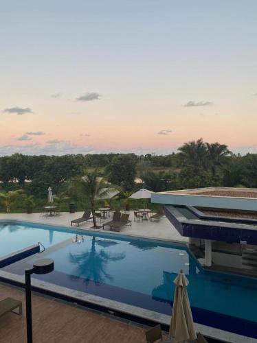 a view of a swimming pool at a resort at Guarajuba Cond Paraiso dos Coqueiros in Camaçari