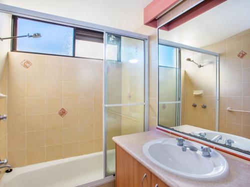 a bathroom with a sink and a shower and a tub at The Rocks Resort Unit 9J in Gold Coast