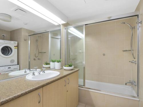 a bathroom with a sink and a shower and a tub at The Rocks Resort Unit 3D in Gold Coast