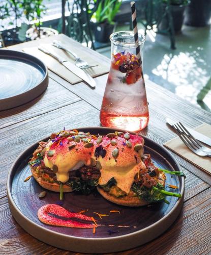 a plate with a sandwich on a table with a drink at Quest North Sydney in Sydney