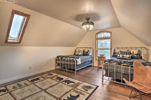 a attic bedroom with two beds and a window at Near Bear Mountain and Big Bear Lake Gem with Hot Tub in Big Bear Lake