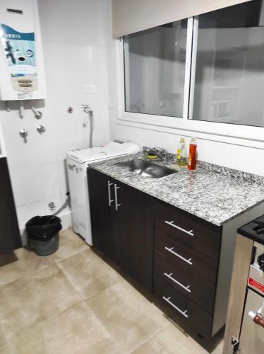 a small kitchen with a sink and a dishwasher at OBELISCO SARMIENTO CENTER in Buenos Aires
