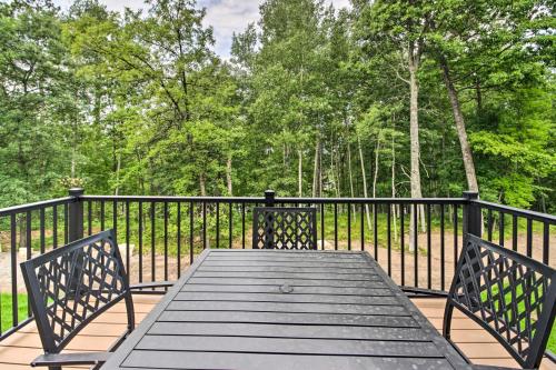 a wooden table with two benches on a black fence at Upscale Townhome in Causeways on Gull Resort! in Nisswa
