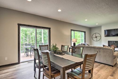 a dining room and living room with a table and chairs at Upscale Townhome in Causeways on Gull Resort! in Nisswa