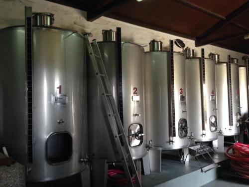 a row of water tanks lined up against a wall at Quinta dos Espinheiros in Provesende