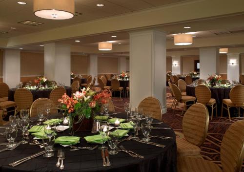 a banquet hall with tables and chairs with flowers on them at Kimpton Hotel Monaco Denver by IHG in Denver