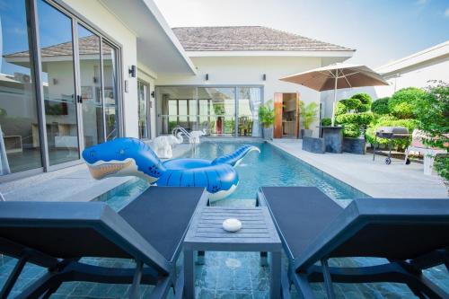 a pool in a house with a pool slide in the backyard at Yipmunta Pool Villa - SHA Plus Certified in Bang Tao Beach