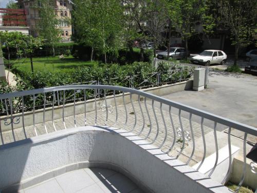 a metal railing on a staircase in a park at Tatjana's Apartments Ohrid in Ohrid