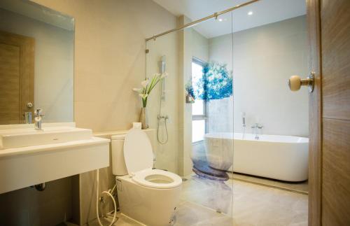a bathroom with a toilet and a sink and a tub at Yipmunta Pool Villa - SHA Plus Certified in Bang Tao Beach