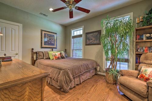 a bedroom with a bed and a couch and a fan at Extravagant 4,500 Sq Ft Home in Hill Country! in Spring Branch