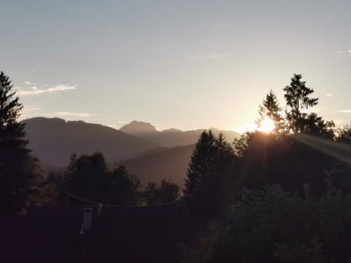 a sunset in the mountains with the sun setting at Haus Seewald in Passriach