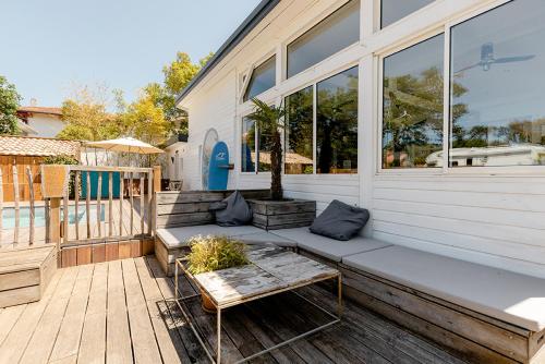 a porch of a house with a bench on it at Board 'n Breakfast in Labenne