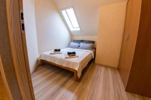 a small bedroom with a bed and a window at Leśne zacisze- rowery,łódka,kajak in Kallinowen