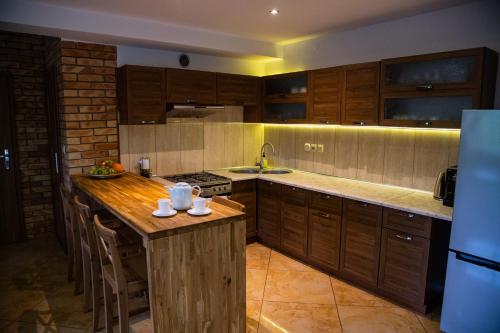 a kitchen with wooden cabinets and a wooden counter top at Leśne zacisze- rowery,łódka,kajak in Kallinowen