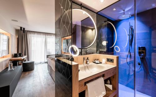 a bathroom with a sink and a mirror at BAD MOOS - Aqua Spa Resort in Sesto