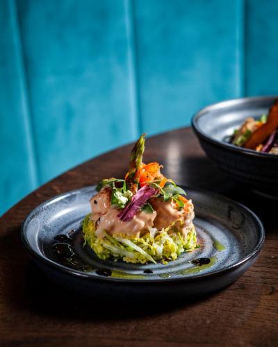 a plate of food on a wooden table at The Clermont London, Victoria in London