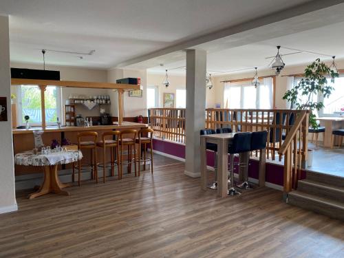 a restaurant with a bar and some tables and chairs at Margarethenhof in Sankt Margarethen