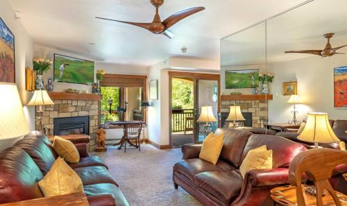 a living room with leather furniture and a fireplace at Lionsquare Lodge North #282 Home in Vail
