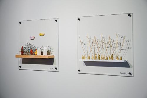 two views of a glass display case with plants at Pavo Art Hotel in Heraklio Town