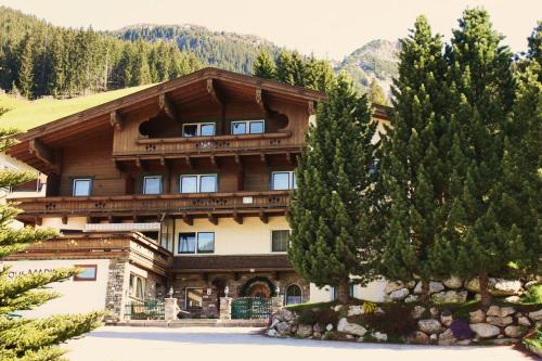 a large building with trees in front of it at Pension Marina in Tux