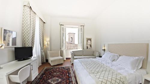 Ένα ή περισσότερα κρεβάτια σε δωμάτιο στο Hotel San Miniato