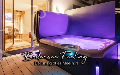 a purple jacuzzi tub sitting in a room at Hotel Restaurant Spa Torkel in Nonnenhorn