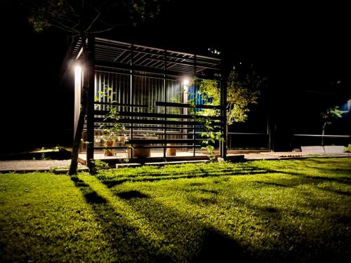 a building with lights on the grass at night at 方圓行止 Funyuan Village in Puli