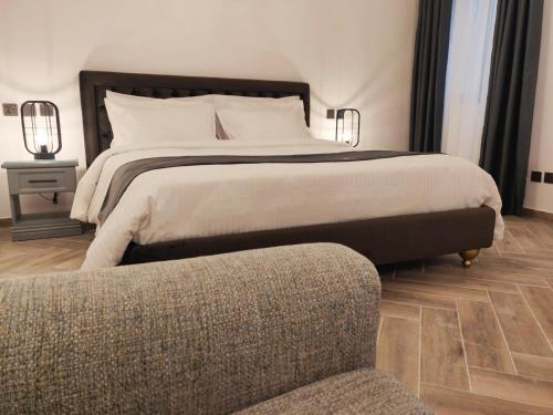 a bedroom with a large bed and a couch at Casa Reale Boutique Hotel in Valletta