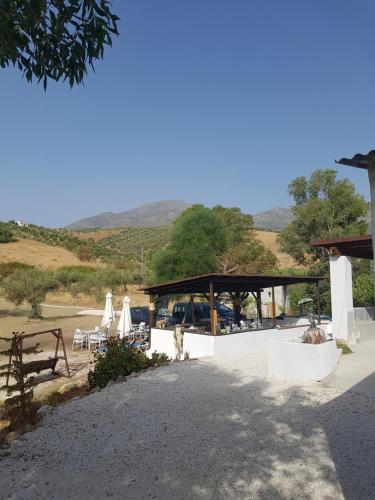 a group of chairs and tables and a pavilion at Amandolas in Casarabonela