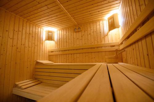 a wooden sauna with a bench in it at Parklands Hotel & Pool in Bansko