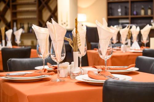 a table set with wine glasses and napkins at Parklands Hotel & Pool in Bansko