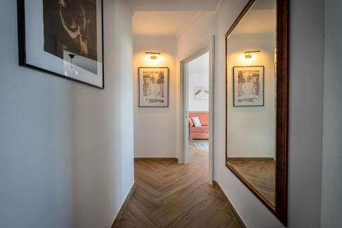 a hallway with a mirror and pictures on the wall at Urbio Private Suites in Cluj-Napoca