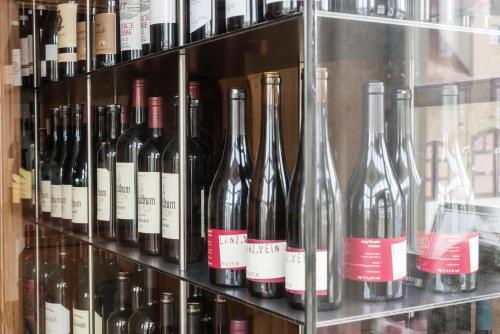 a bunch of wine bottles on display in a store at Hotel Restaurant Spa Torkel in Nonnenhorn