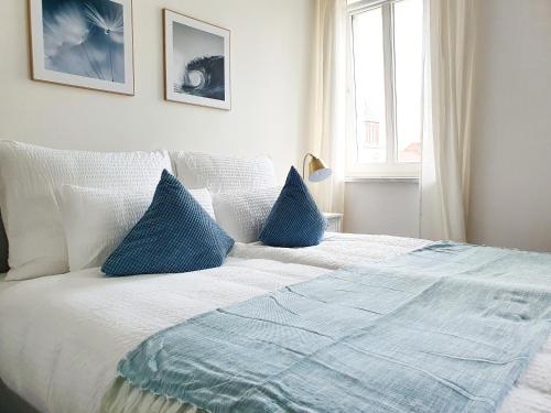 a bedroom with a bed with blue pillows at PB Ferienwohnungen - FeWo 7 - Stilvoll eingerichtetes Apartment im Herzen Senftenbergs in Senftenberg