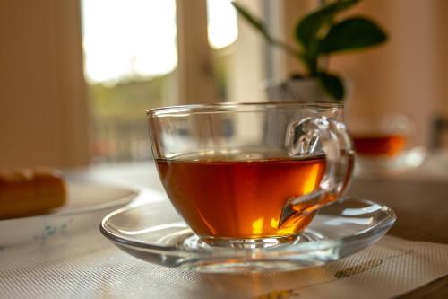 a glass cup of tea on a plate on a table at Casa Dolce Casa - Casa Vacanze in Ariano Irpino